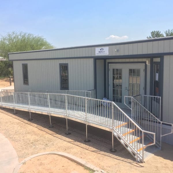 A building with a ramp leading to the front door.