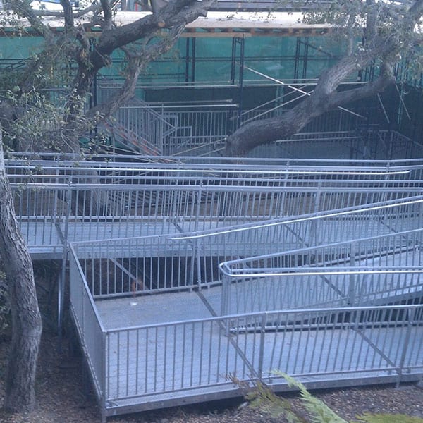 A group of cages in the middle of a field.