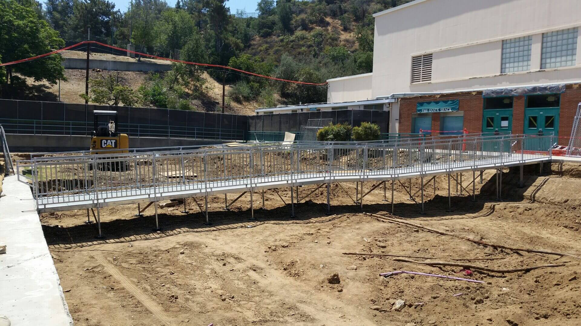 A construction site with metal rails and concrete.